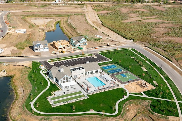 birds eye view of property with a water view