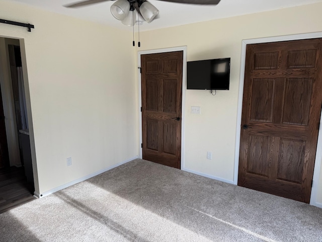 unfurnished bedroom featuring carpet floors and ceiling fan