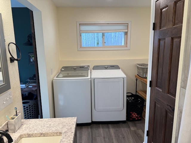 laundry room with separate washer and dryer and dark wood-type flooring