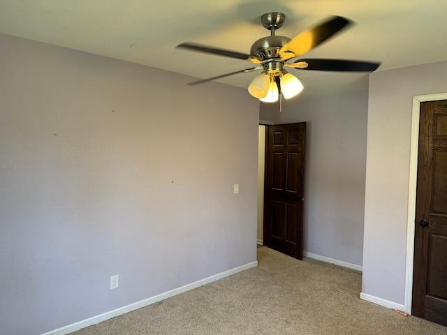 empty room with light colored carpet and ceiling fan