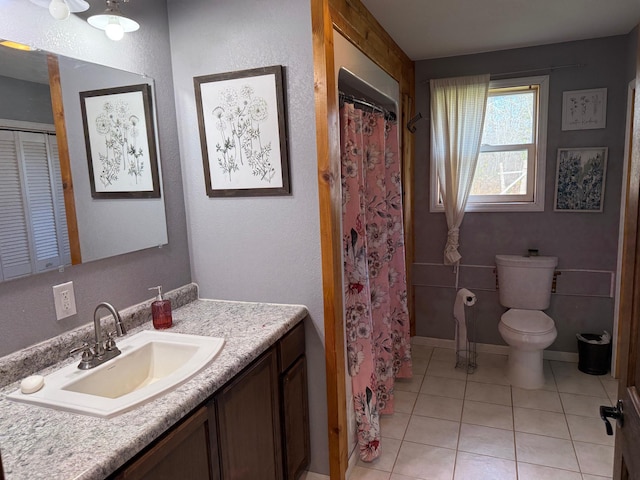 bathroom featuring vanity, tile patterned flooring, toilet, and a shower with curtain