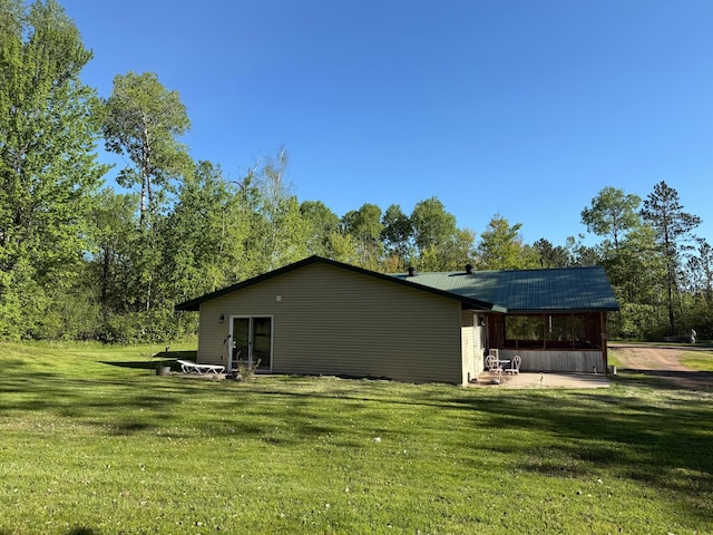 41574 Koland Rd, Sandstone Twp, MN 55072 - view of property exterior featuring a lawn and a patio