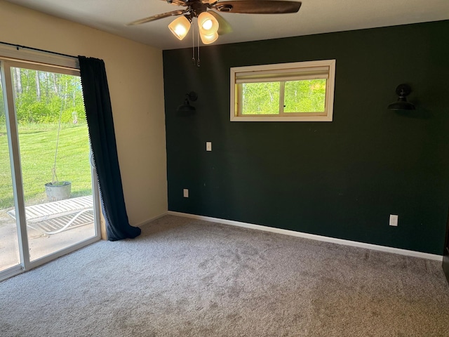 41574 Koland Rd, Sandstone Twp, MN 55072 - carpeted empty room with healthy amount of natural light, ceiling fan, and baseboards