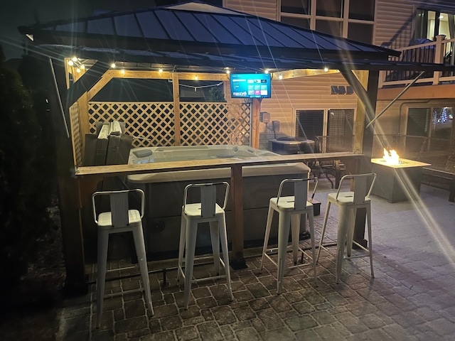 view of patio with a bar and an outdoor fire pit