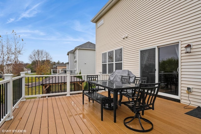 wooden terrace featuring grilling area