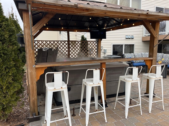 view of patio / terrace with a gazebo and exterior bar