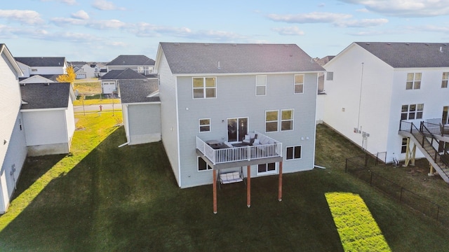 rear view of house featuring a yard