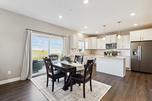 dining area featuring sink and dark wood-type flooring