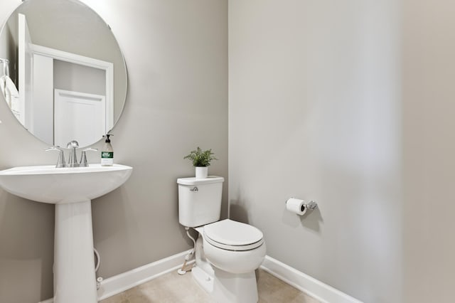 bathroom featuring toilet and tile patterned flooring