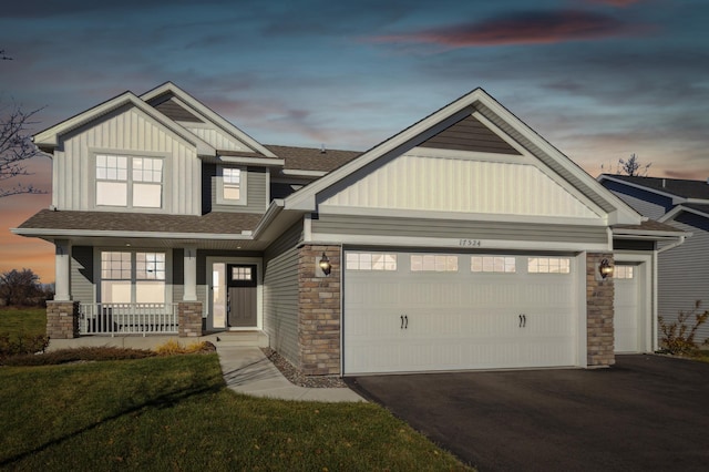 craftsman-style house with covered porch and a garage