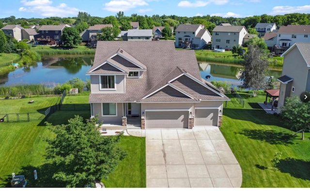 view of front of property with a front lawn and a water view