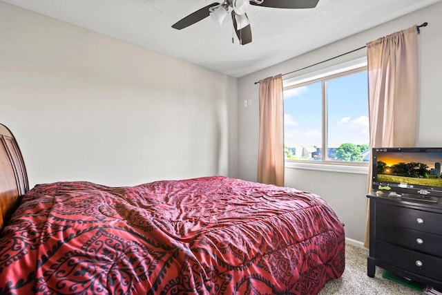 carpeted bedroom with a textured ceiling and ceiling fan