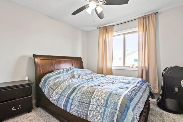 bedroom with a textured ceiling, light carpet, and ceiling fan