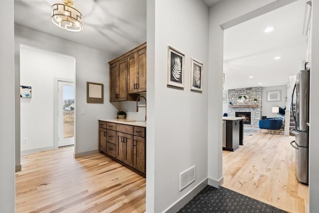 hall featuring sink and light hardwood / wood-style floors