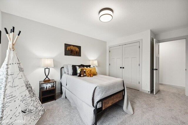 bedroom featuring a closet and light colored carpet