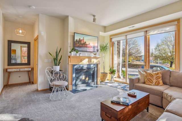 living room with a premium fireplace and carpet flooring