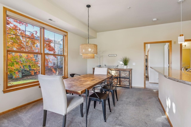 carpeted dining space featuring sink