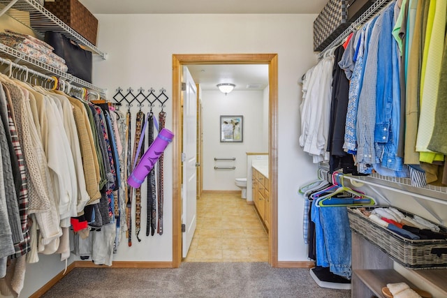 walk in closet featuring light tile patterned flooring