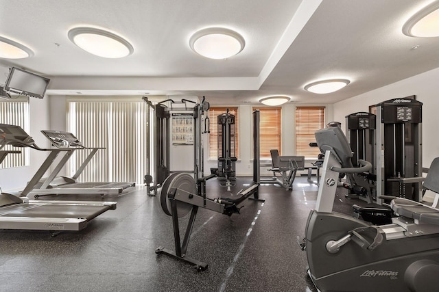 exercise room with a textured ceiling