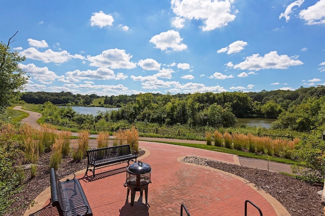 view of home's community with a patio and a water view