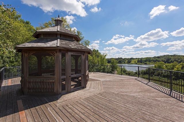 wooden terrace with a water view and a gazebo