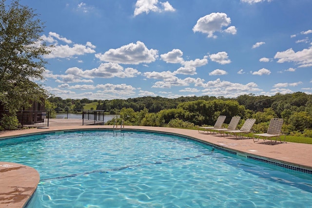 view of pool featuring a water view