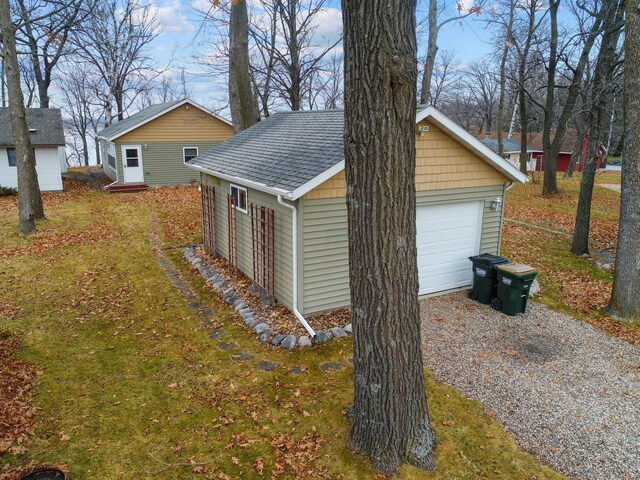 view of property exterior featuring a garage and an outdoor structure