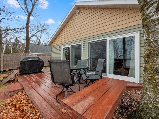 wooden deck with a grill