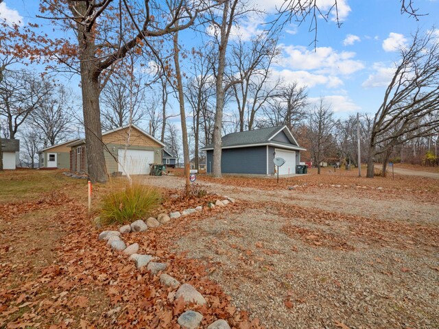 view of home's exterior with a garage and an outbuilding