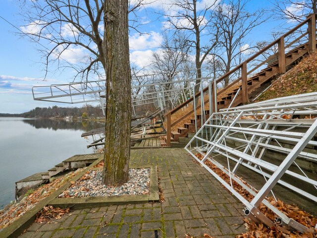 view of yard with a water view and a boat dock