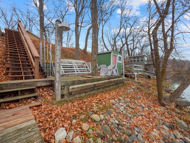 view of yard featuring a trampoline and a wooden deck