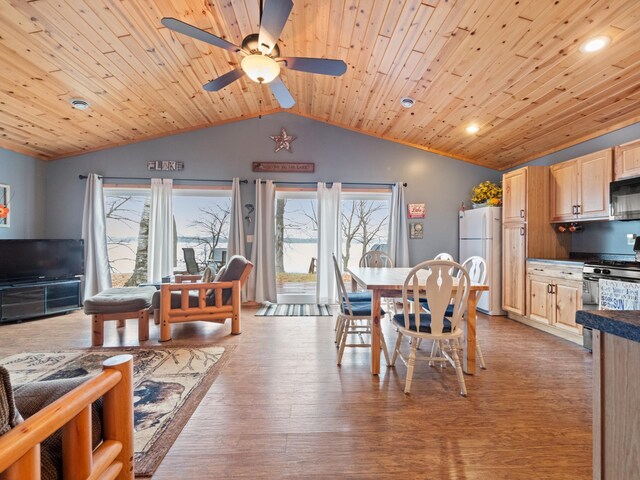 dining room with a wealth of natural light, wood ceiling, and light hardwood / wood-style flooring