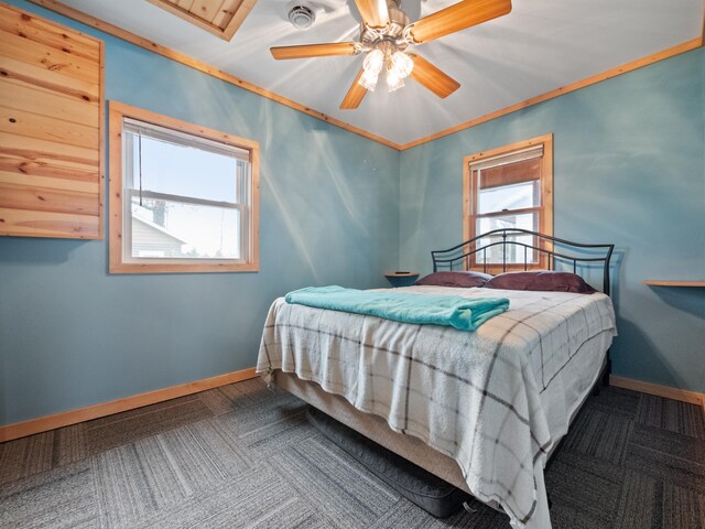 carpeted bedroom with ceiling fan and crown molding