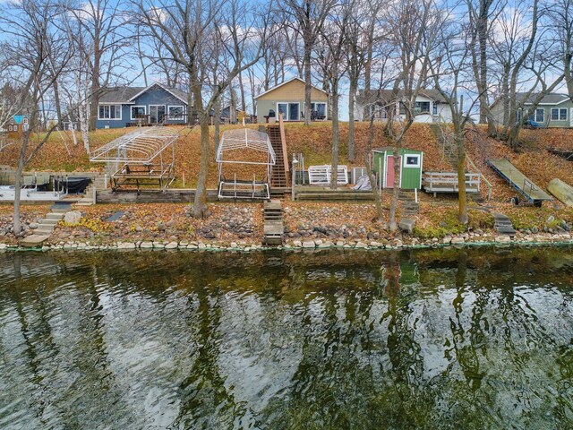 back of property with a water view