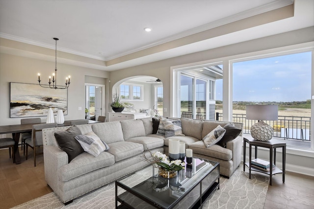 living room featuring ornamental molding, hardwood / wood-style floors, and a chandelier