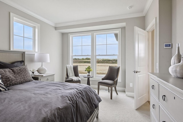 bedroom featuring multiple windows, ornamental molding, and light colored carpet