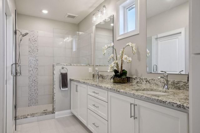 bathroom with vanity, an enclosed shower, and tile patterned floors