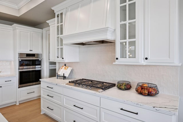 9155 Mills Dr, Chanhassen, MN 55317 - kitchen with white cabinetry, light wood finished floors, light stone counters, and stainless steel appliances