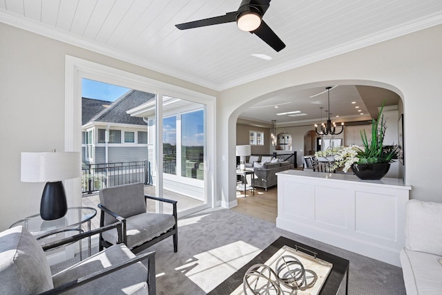 9155 Mills Dr, Chanhassen, MN 55317 - living area with arched walkways, crown molding, carpet floors, and ceiling fan with notable chandelier