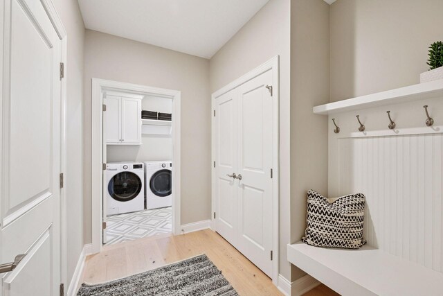 9155 Mills Dr, Chanhassen, MN 55317 - washroom with light wood finished floors, laundry area, baseboards, and washing machine and clothes dryer
