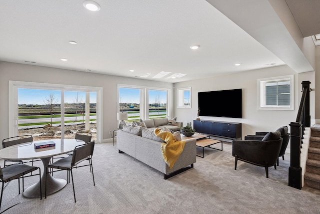 9155 Mills Dr, Chanhassen, MN 55317 - living area with light colored carpet, recessed lighting, a healthy amount of sunlight, and stairs