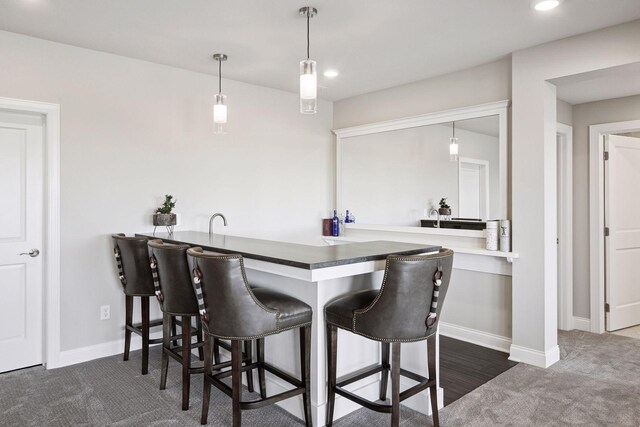 9155 Mills Dr, Chanhassen, MN 55317 - bar featuring pendant lighting, dark colored carpet, baseboards, and recessed lighting