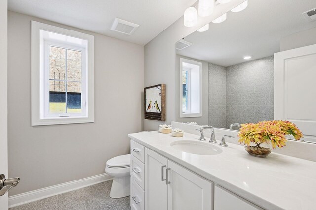 9155 Mills Dr, Chanhassen, MN 55317 - bathroom with toilet, vanity, visible vents, granite finish floor, and baseboards