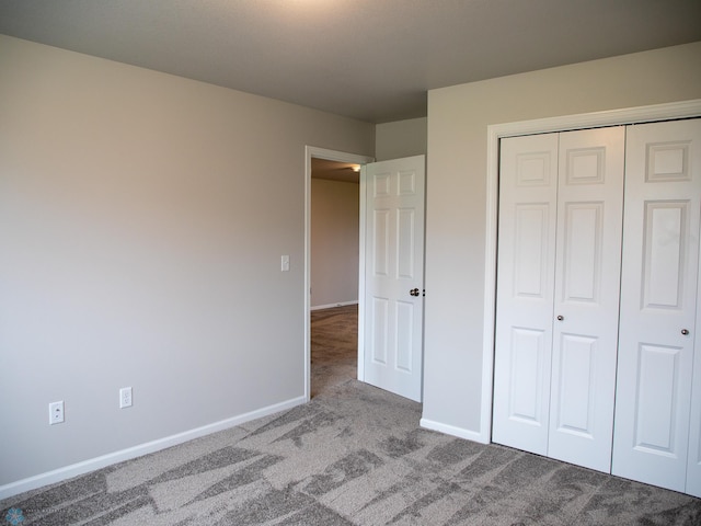 unfurnished bedroom with light carpet and a closet