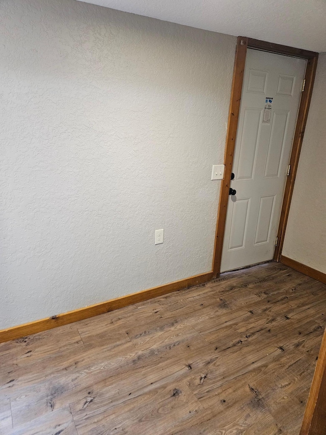 unfurnished room with wood-type flooring