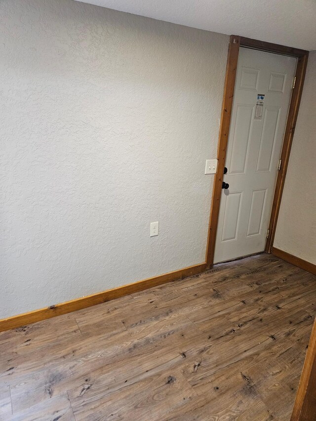 unfurnished room featuring hardwood / wood-style flooring