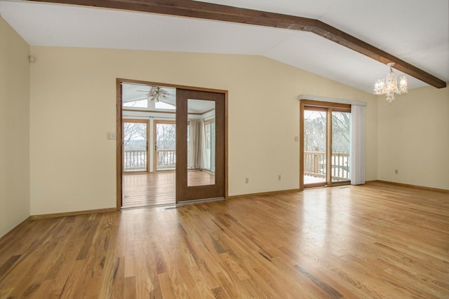 spare room with ceiling fan with notable chandelier, lofted ceiling with beams, and light hardwood / wood-style flooring