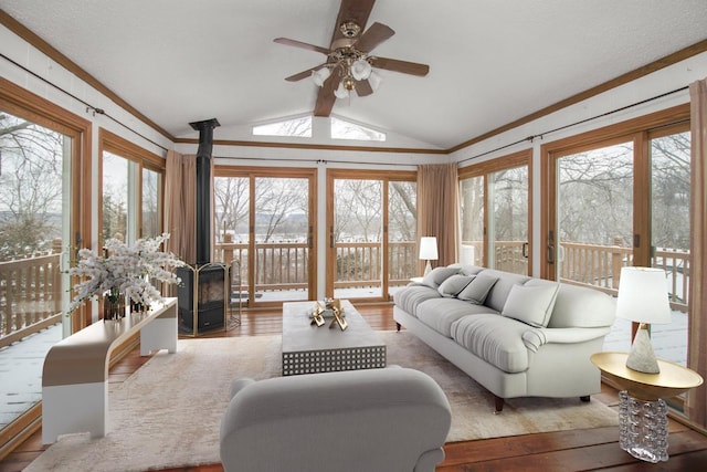 living room featuring hardwood / wood-style flooring, vaulted ceiling, ornamental molding, and ceiling fan