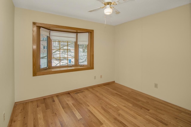 empty room featuring ceiling fan and light wood-type flooring