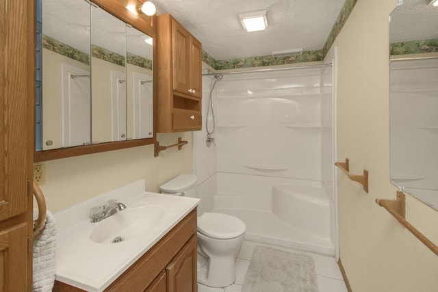 bathroom with vanity, a shower, a textured ceiling, tile patterned floors, and toilet